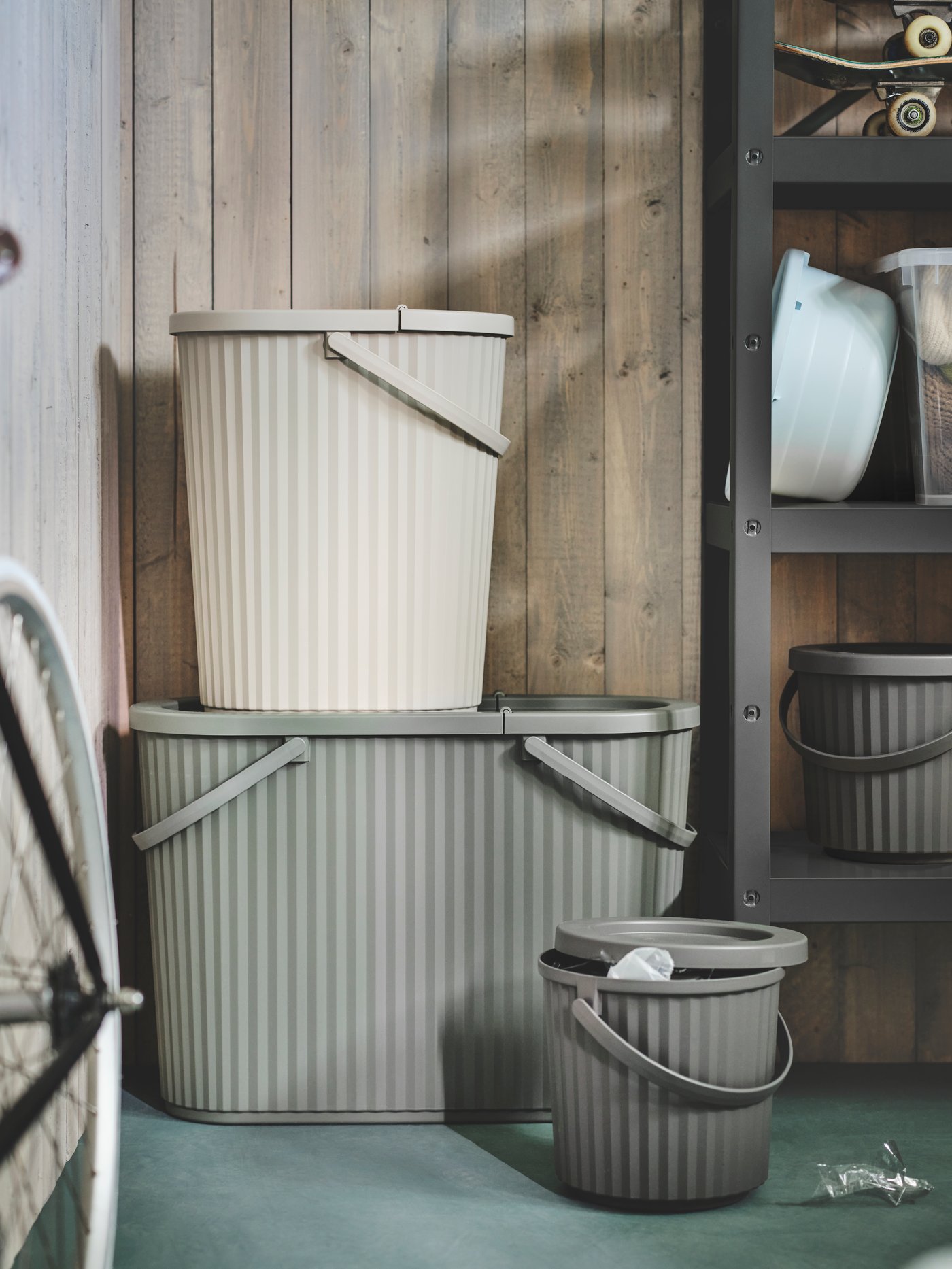 A grey-green DAMMÄNG bin with lid.