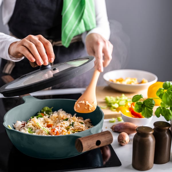 A light orange/dark red KNORRHANE spoon for cooking