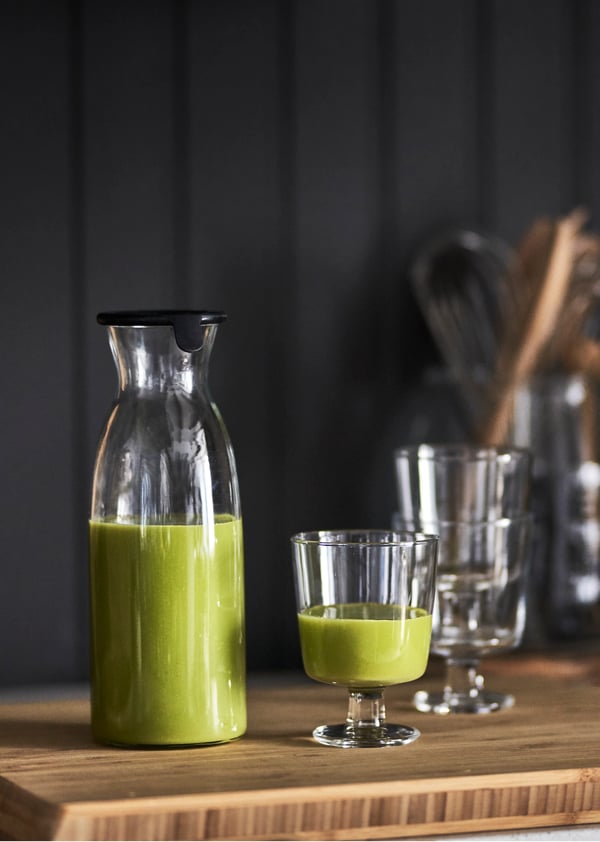 A clear glass VARDAGEN carafe with lid in the dining room
