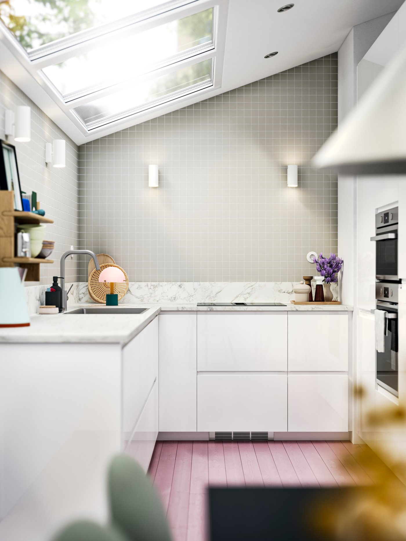 A modern kitchen with sleek VOXTORP white kitchen fronts in a space with a skylight ceiling, and a worktop with marble effect.