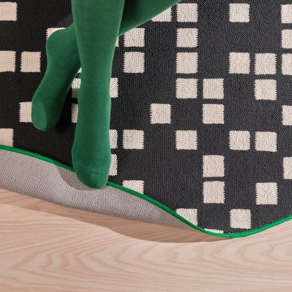 A black BRÄNNBOLL gaming rug
