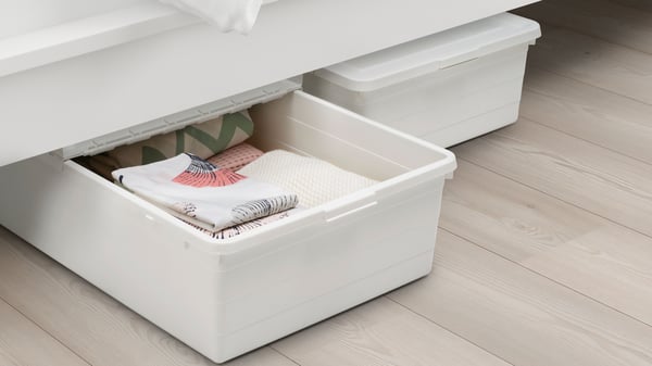 A white SOCKERBIT storage box with lid in the bedroom