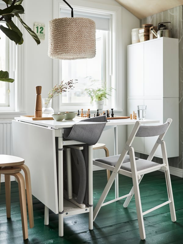 A white/light grey KALLHÄLL gateleg table with storage