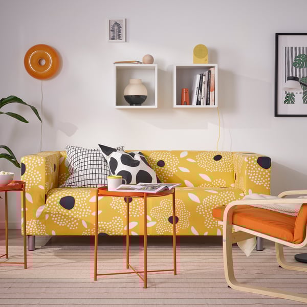 A bright orange GLADOM tray table in the living room