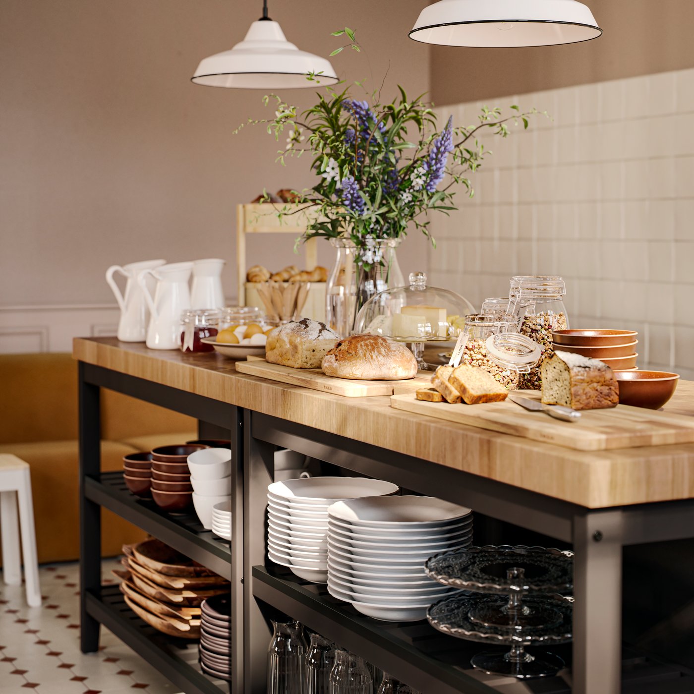 A breakfast buffet, including KORKEN glass jars with lids that have jam and granola inside, is on two wooden kitchen islands.