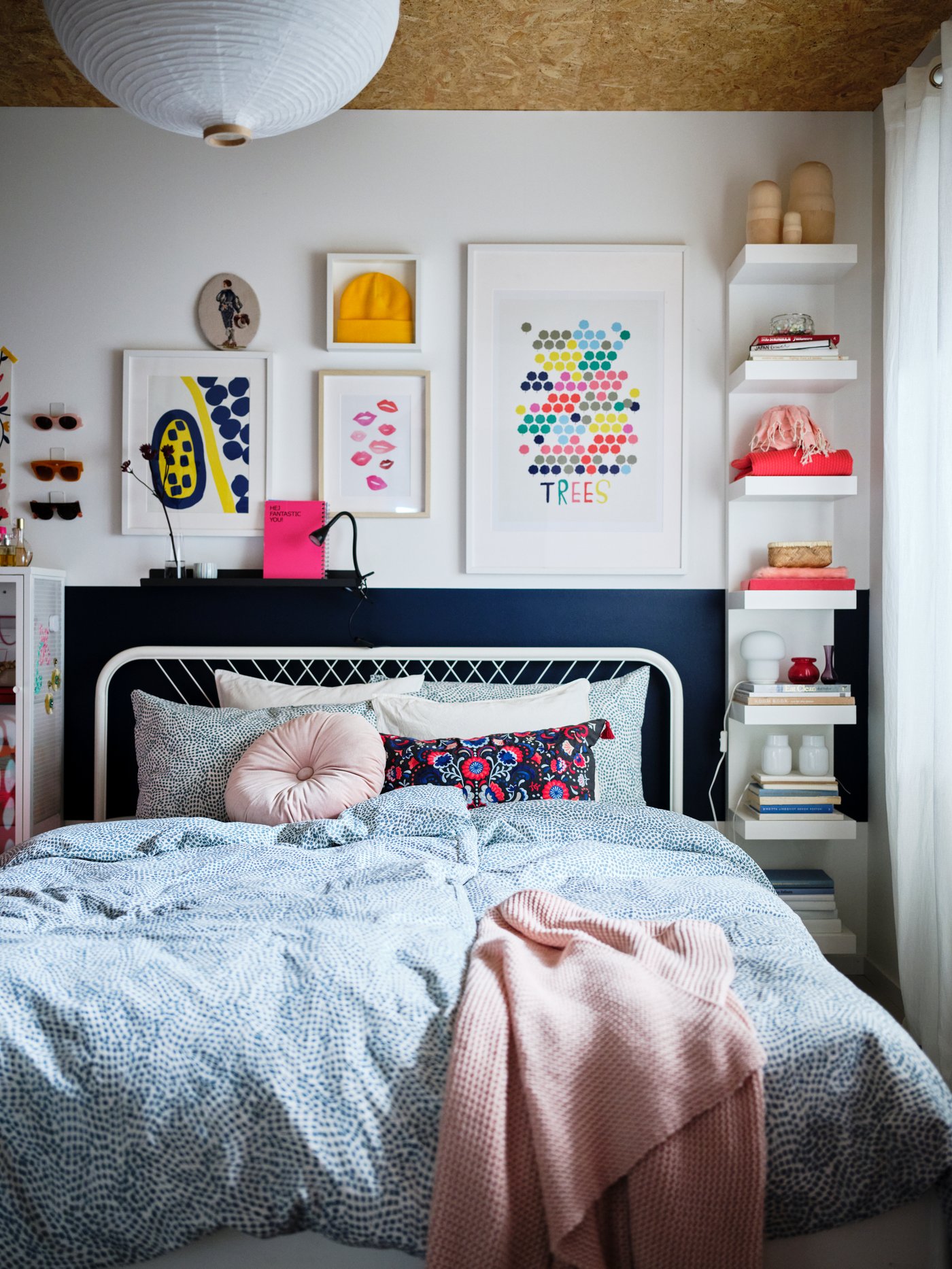 A white LACK wall shelf unit mounted vertically on the wall, in the bedroom.