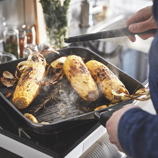 A non-stick coating/stainless steel MIDDAGSMAT grill pan in the kitchen