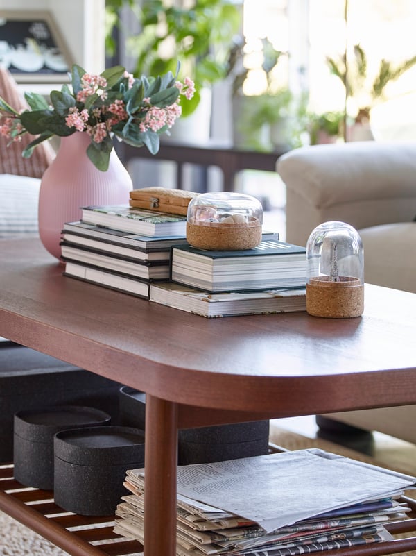 IKEA LISTERBY rectangular brown coffee table, storing books and boxes on a slated shelf below.