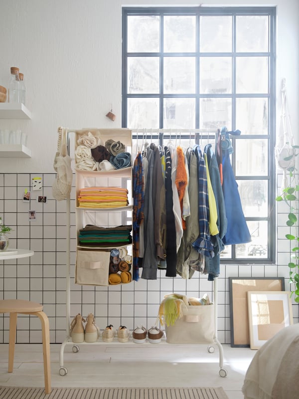 A white RIGGA clothes rack in the bedroom