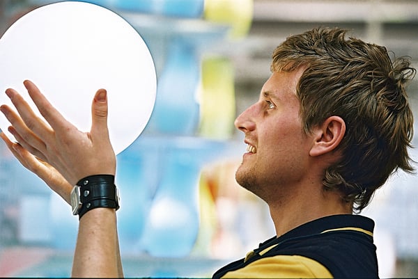 Sales co-worker holding a lamp. 