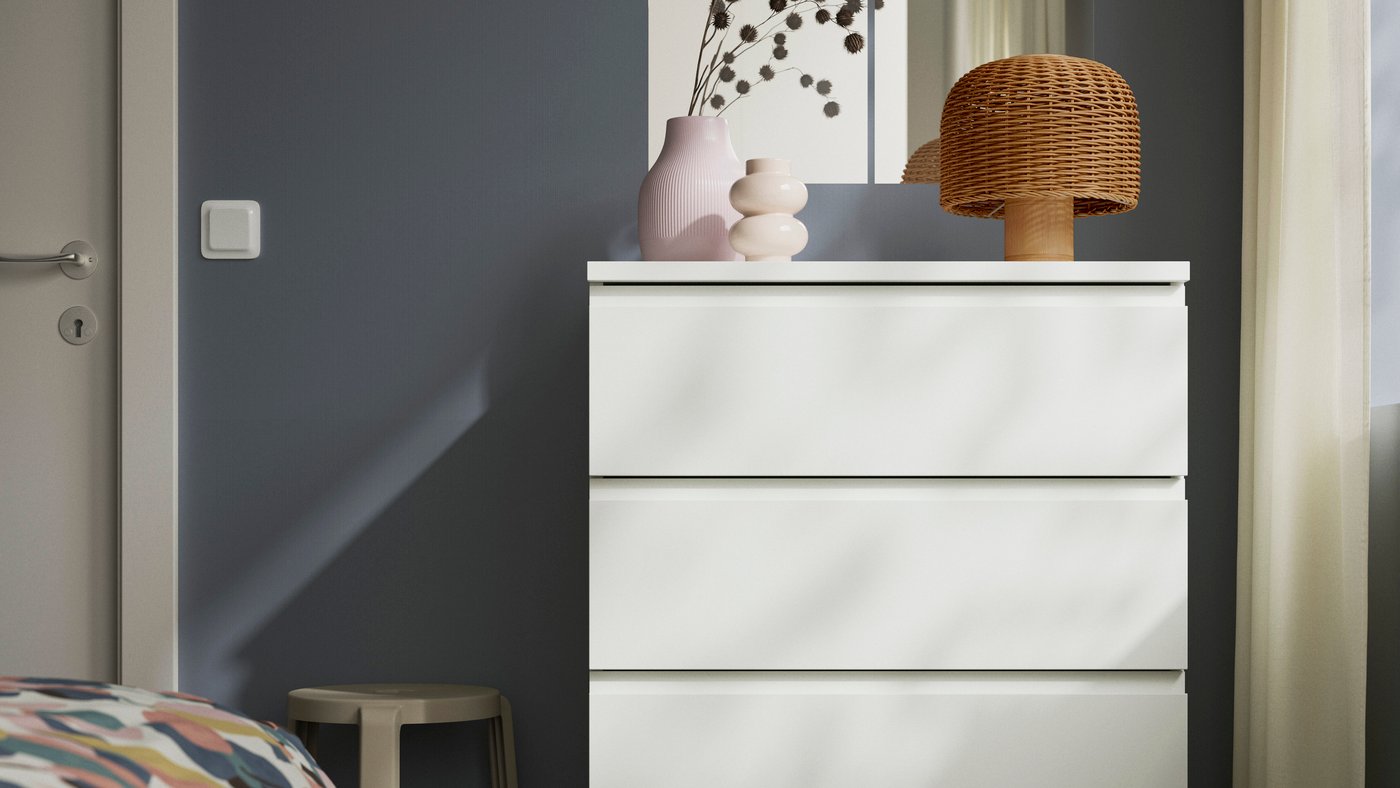 a white STORKLINTA chest of drawers in a bedroom