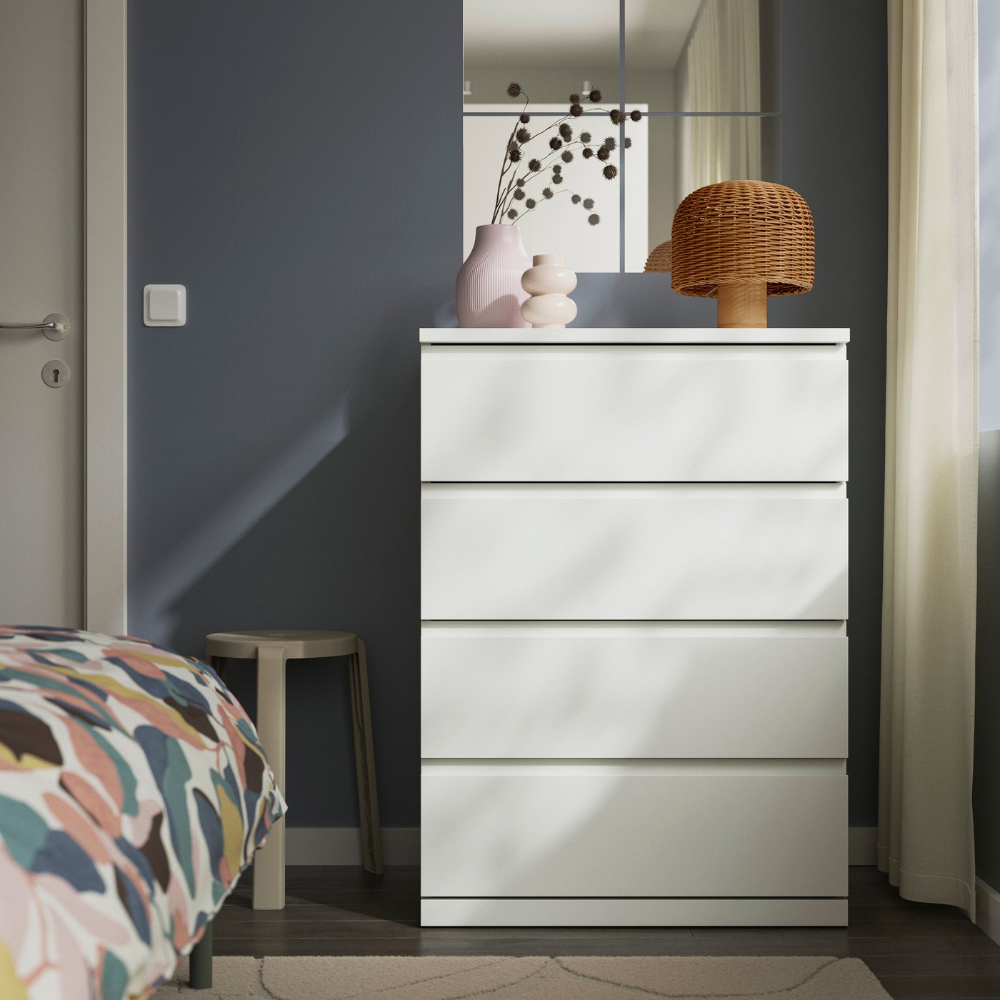 a white STORKLINTA chest of drawers in a bedroom