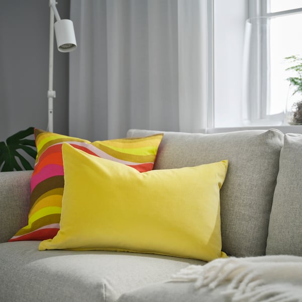 A light yellow SANELA cushion cover