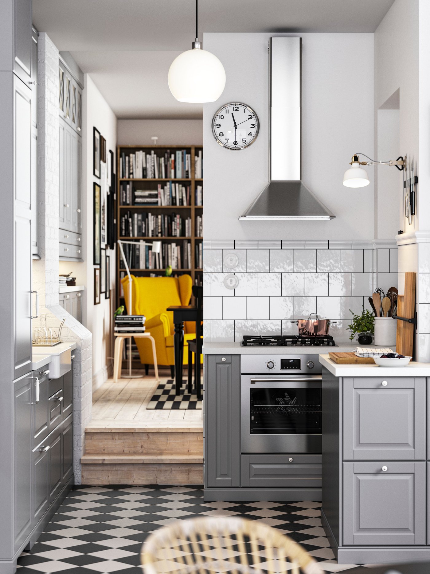 A kitchen with a chequered floor, grey BODBYN fronts with off-white/chrome plated handles and knobs, plus a pendant lamp.