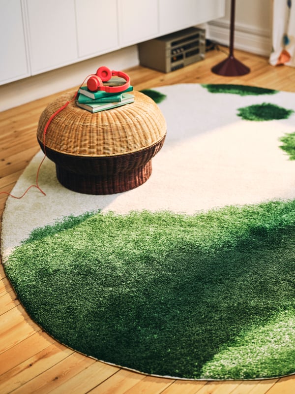 An oval/green off-white IKEA PS 2026 rug, low pile