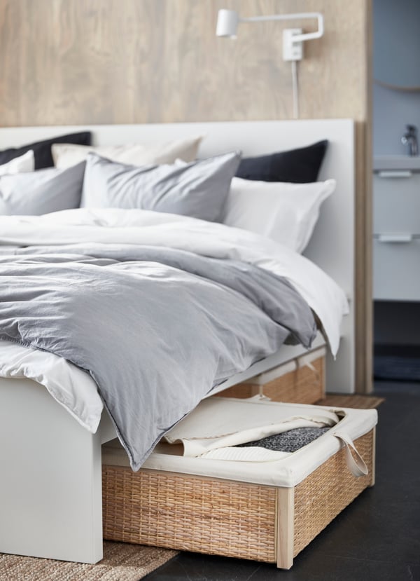 A white MALM bed frame, high in the bedroom