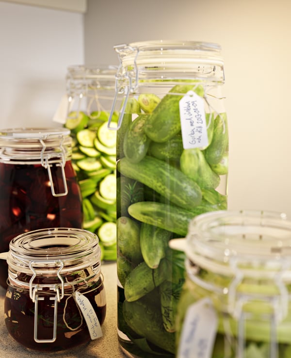 KORKEN food storage jars with pickled food items in them.