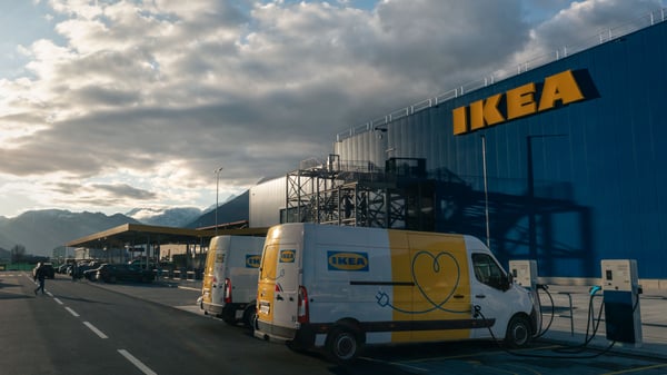 Two IKEA delivery EVs are at a charging point outside an IKEA store in Switzerland.
