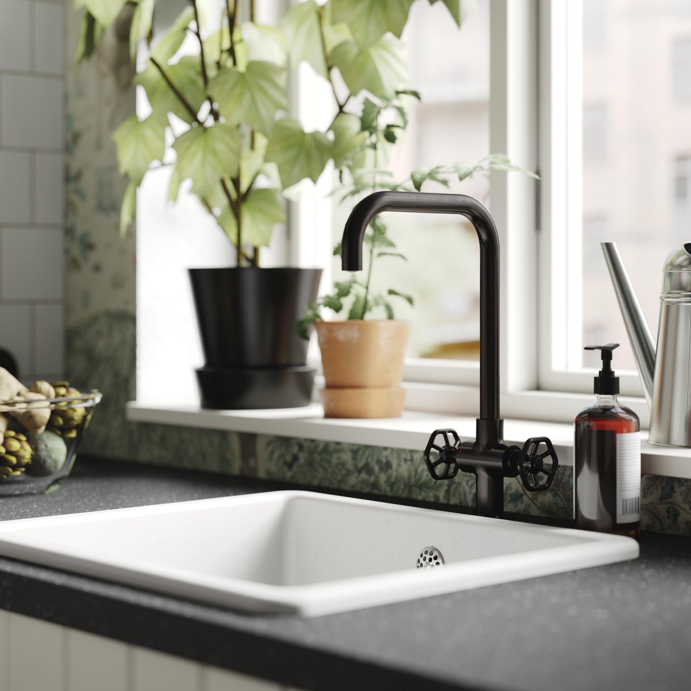 A brushed black metal GAMLESJÖN dual-control kitchen mixer tap in the kitchen