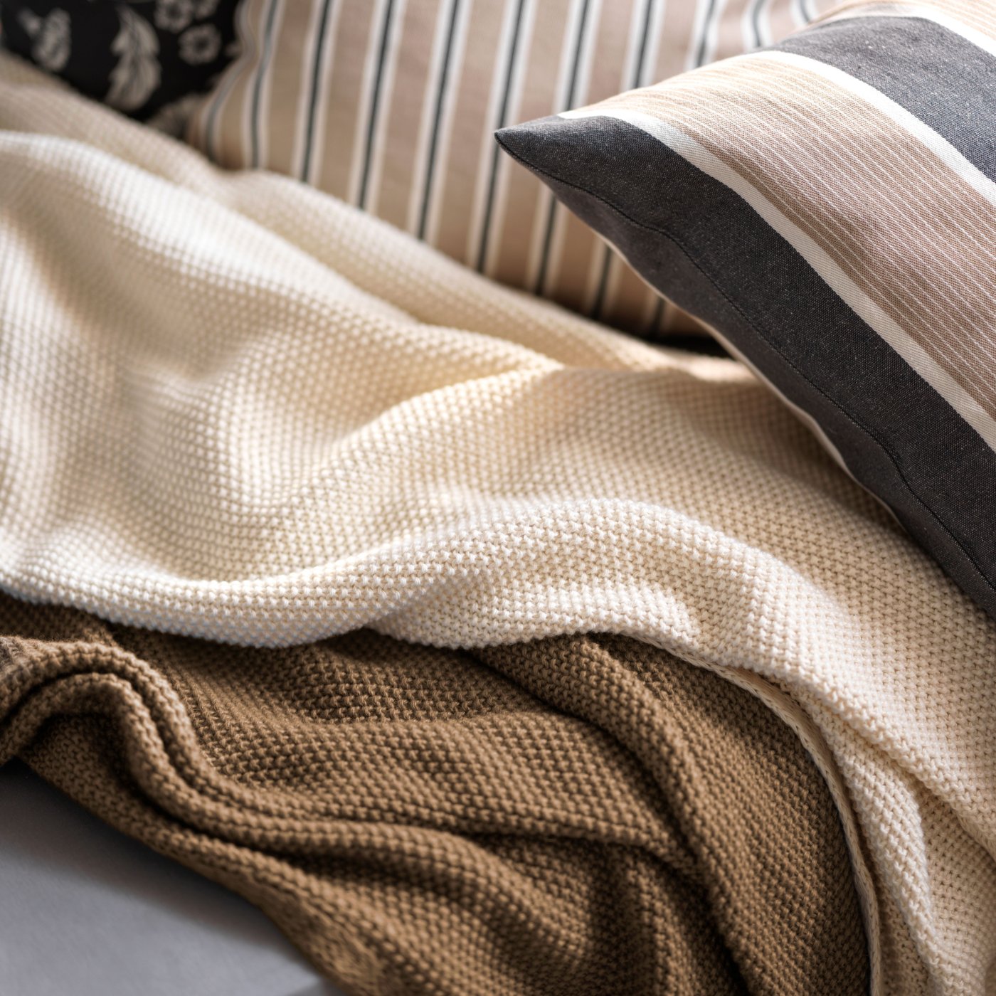 A beige white/stripe pattern KORALLBUSKE cushion cover
