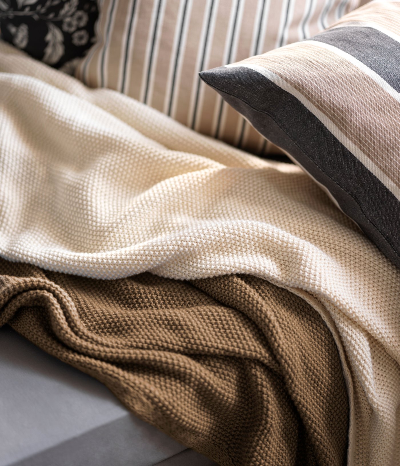 A beige white/stripe pattern KORALLBUSKE cushion cover
