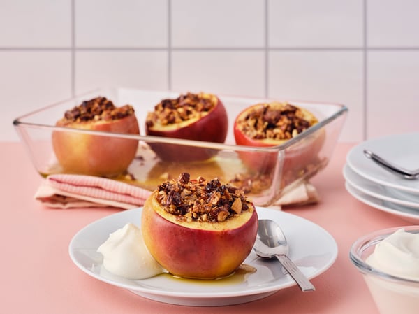 Apples with the top cut off and almonds inside of them.