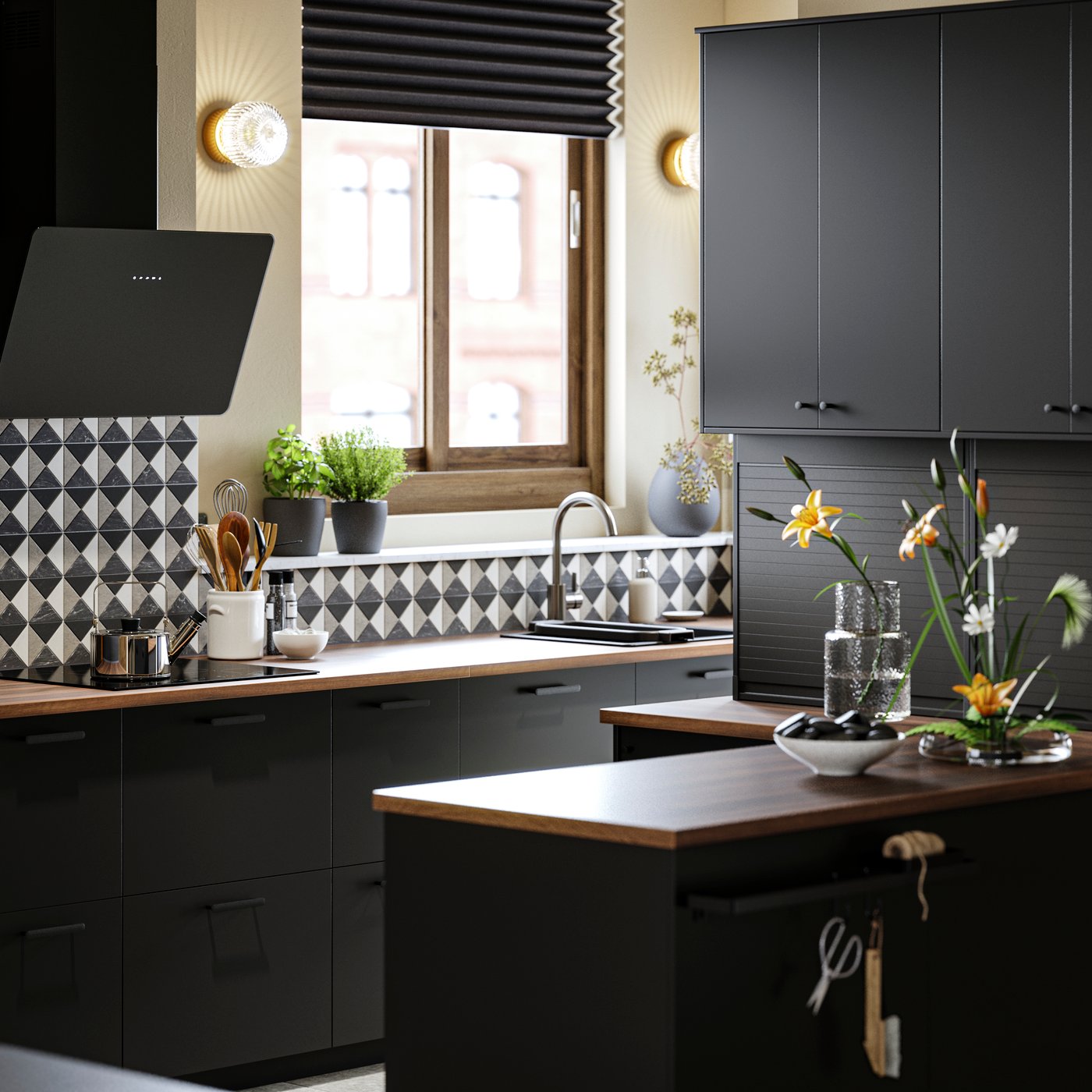 A kitchen with NICKEBO doors in anthracite, a FINSMAKARE wall mounted extractor hood in black and PERSILLADE plant pots.