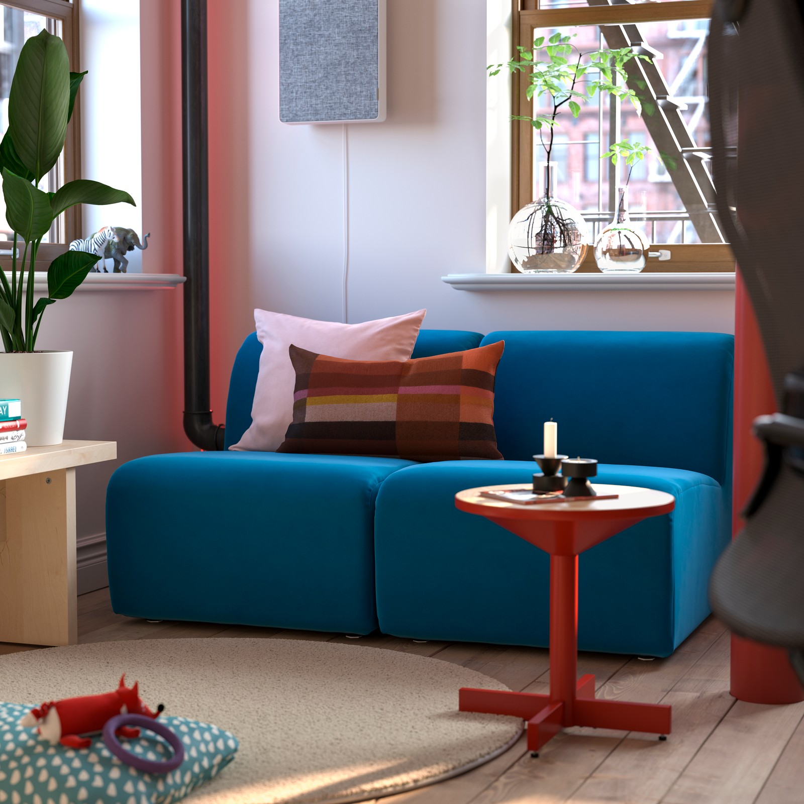 Two STOCKHOLM 1-seat sections are in a corner of a room with a GRIMSARBO side table, STOENSE rug and FÖRNUFTIG air purifier.