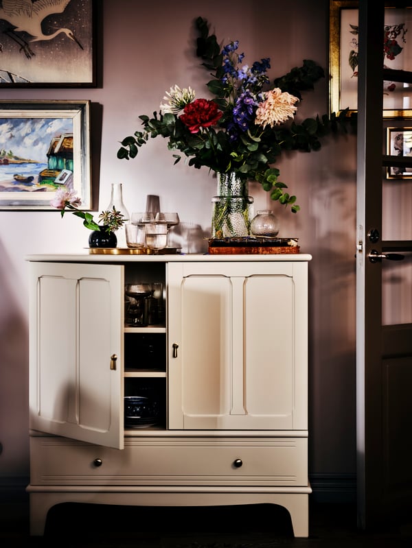 Large artificial bouquet on a traditional cabinet in the living room