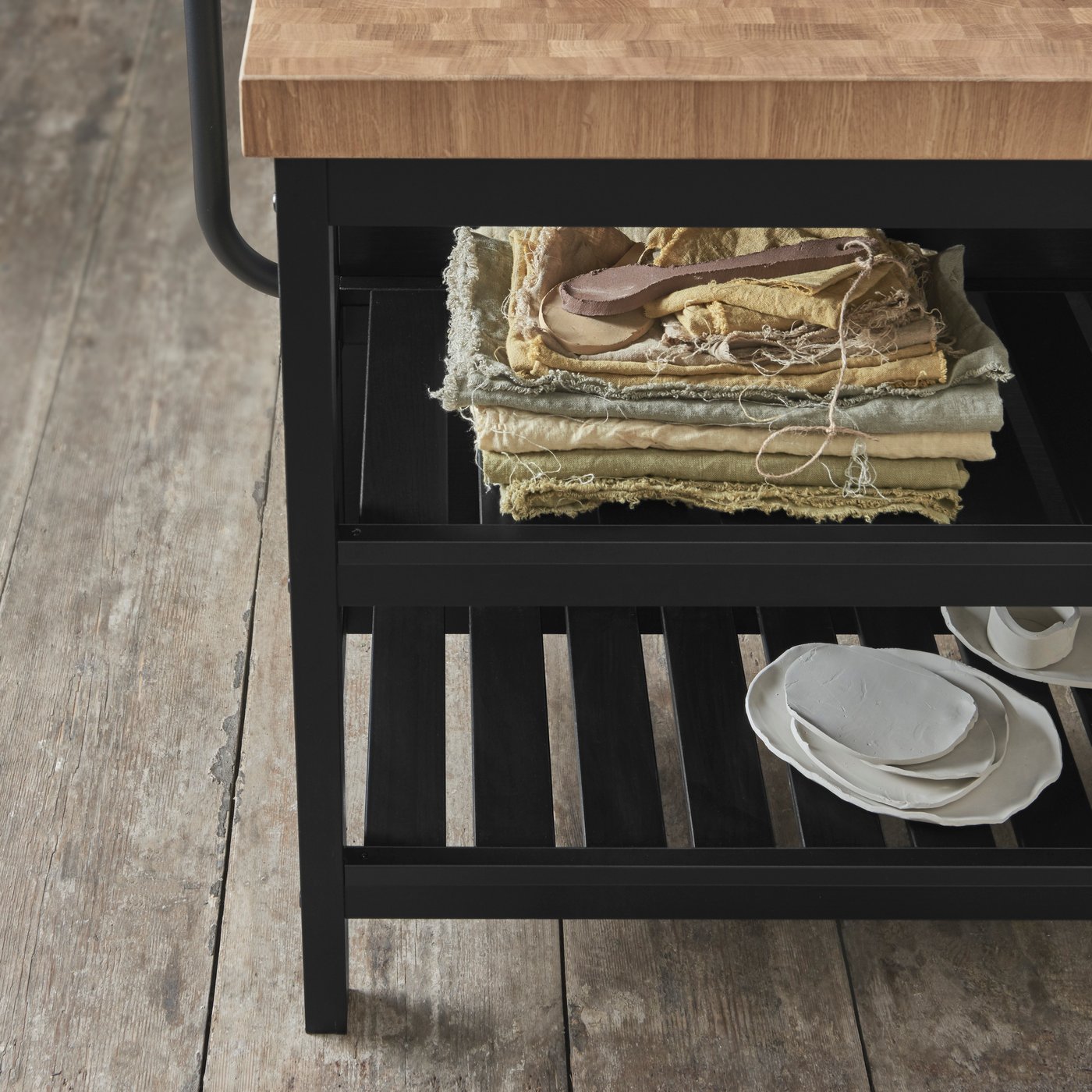 Black VADHOLMA island with towels stacked on shelf