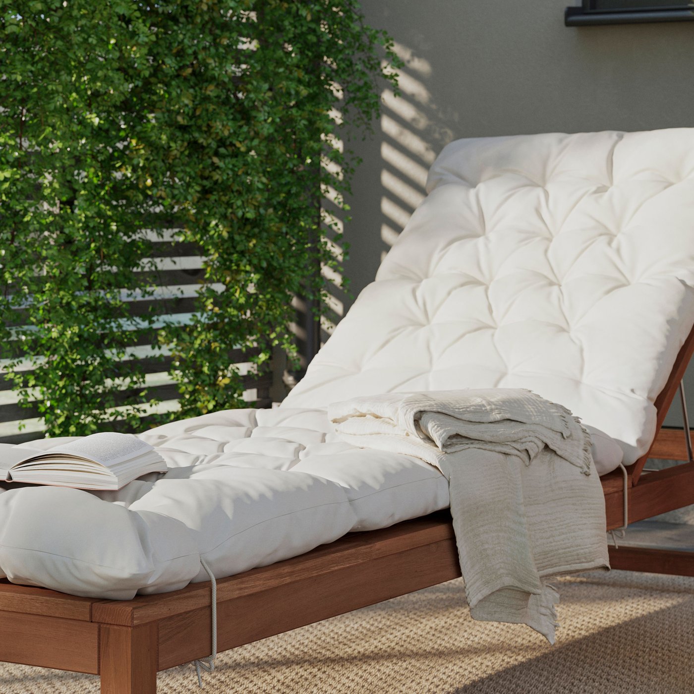 An outdoor light brown stained NÄMMARÖ sun lounger