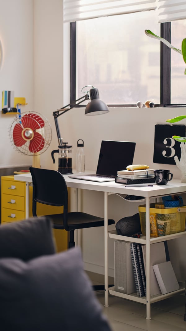 A home study place with a white LAGKAPTEN / SPÄND desk with a black SMÄLLEN swivel chair and a TERTIAL desk lamp.