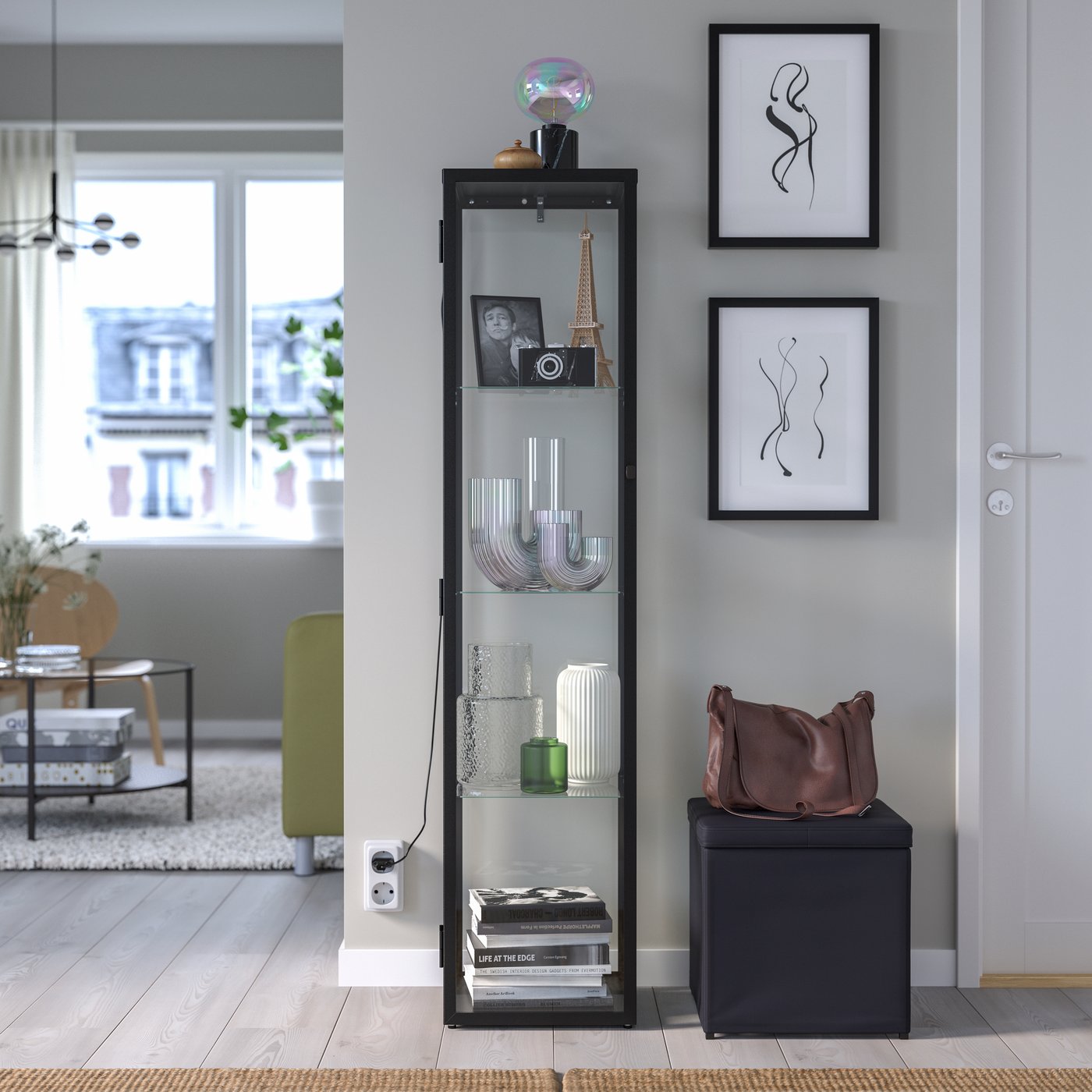 A black BLÅLIDEN glass-door cabinet in the living room