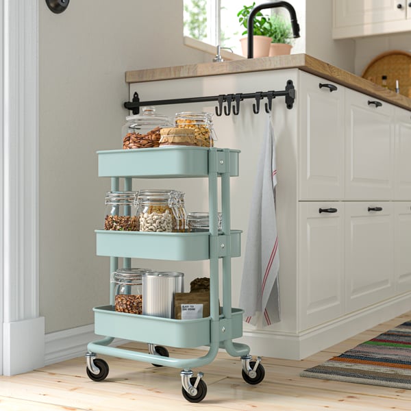 A light turquoise RÅSKOG trolley
