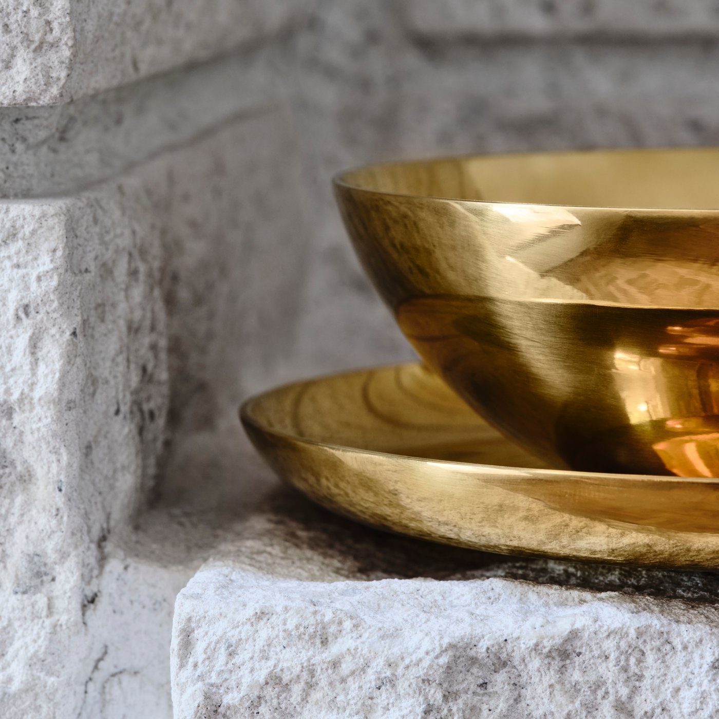A brass-colour STOCKHOLM 2025 bowl and dish