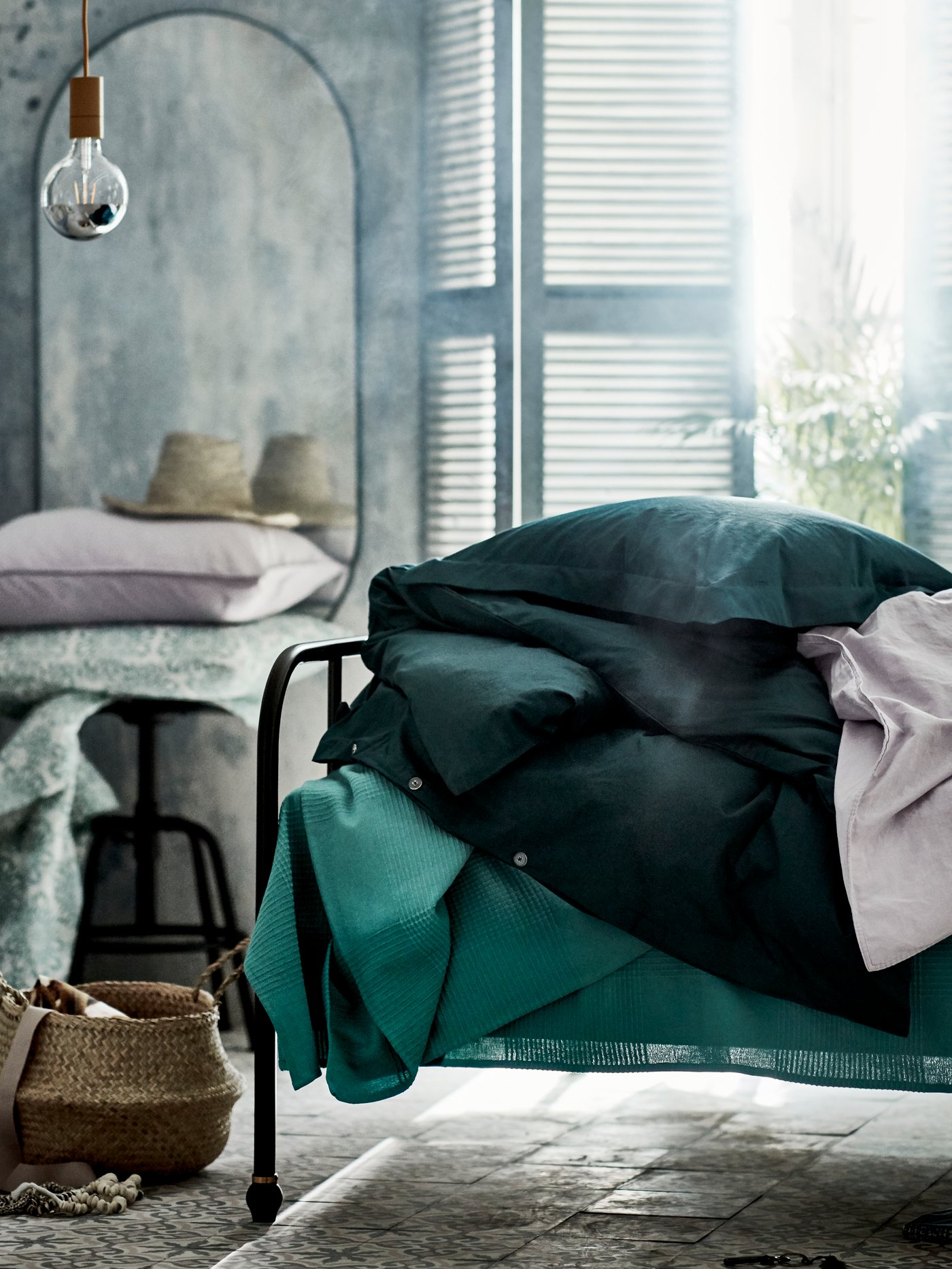 LUKTJASMIN duvet cover and pillowcases in grey-turquoise are placed on a bed. 