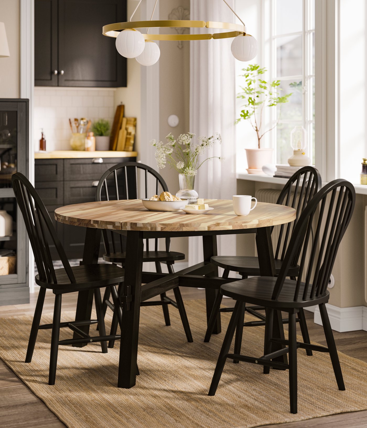 An acacia/black SKOGSTA dining table in the dining room