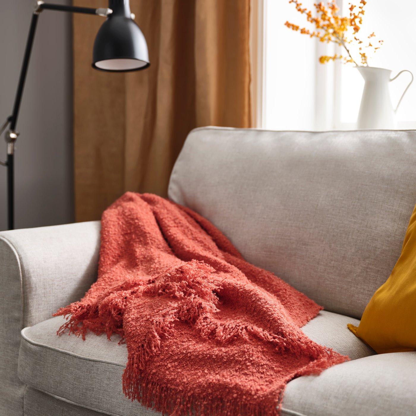 An orange-red SANDBRODD throw