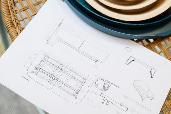Squetch of a floor plan lays on a table.