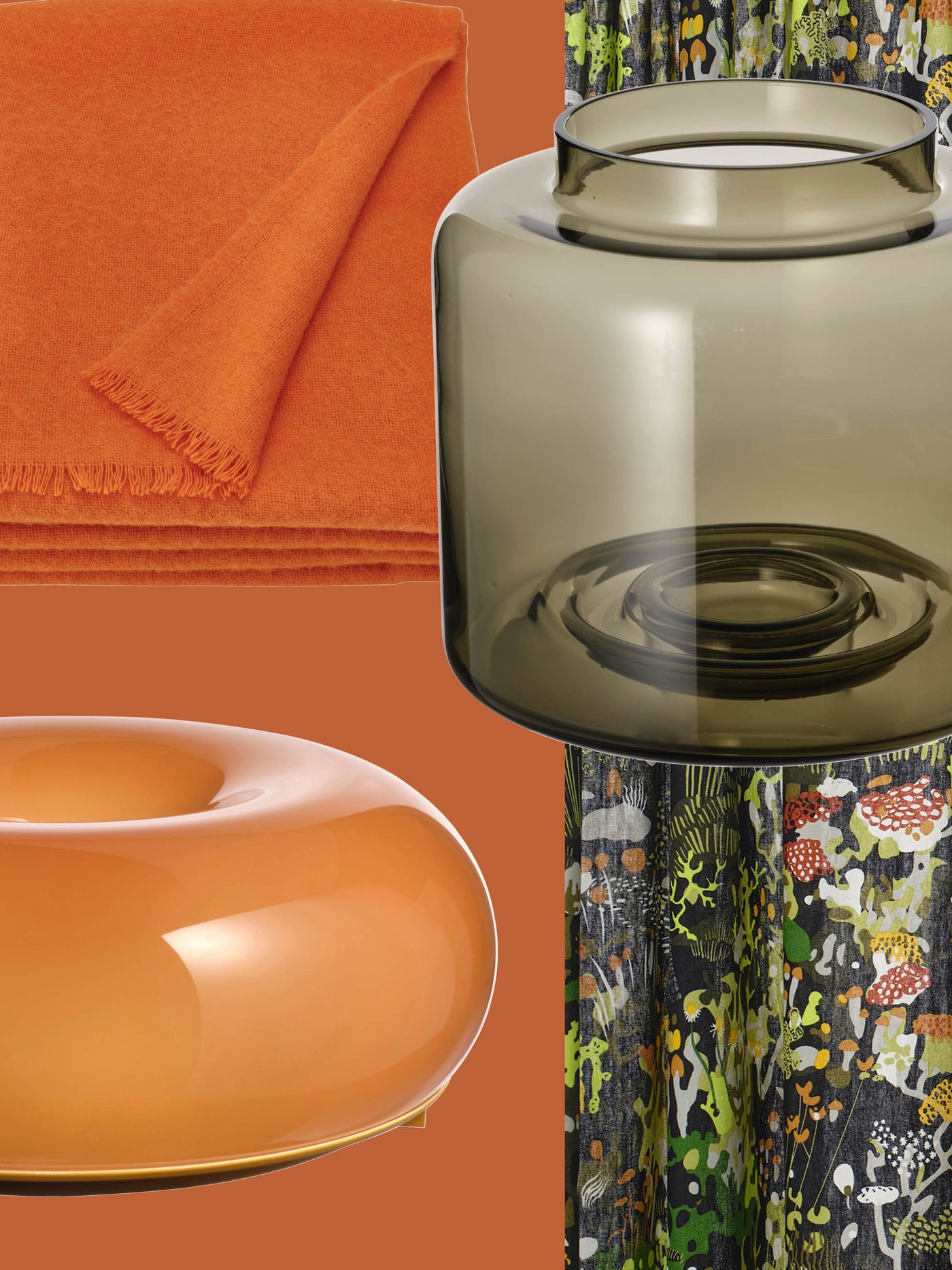 A mix of colorful décor items, including an orange throw, a sculptural bowl and a smoky glass vase, reflects the retro aesthetic often seen in IKEA collections.