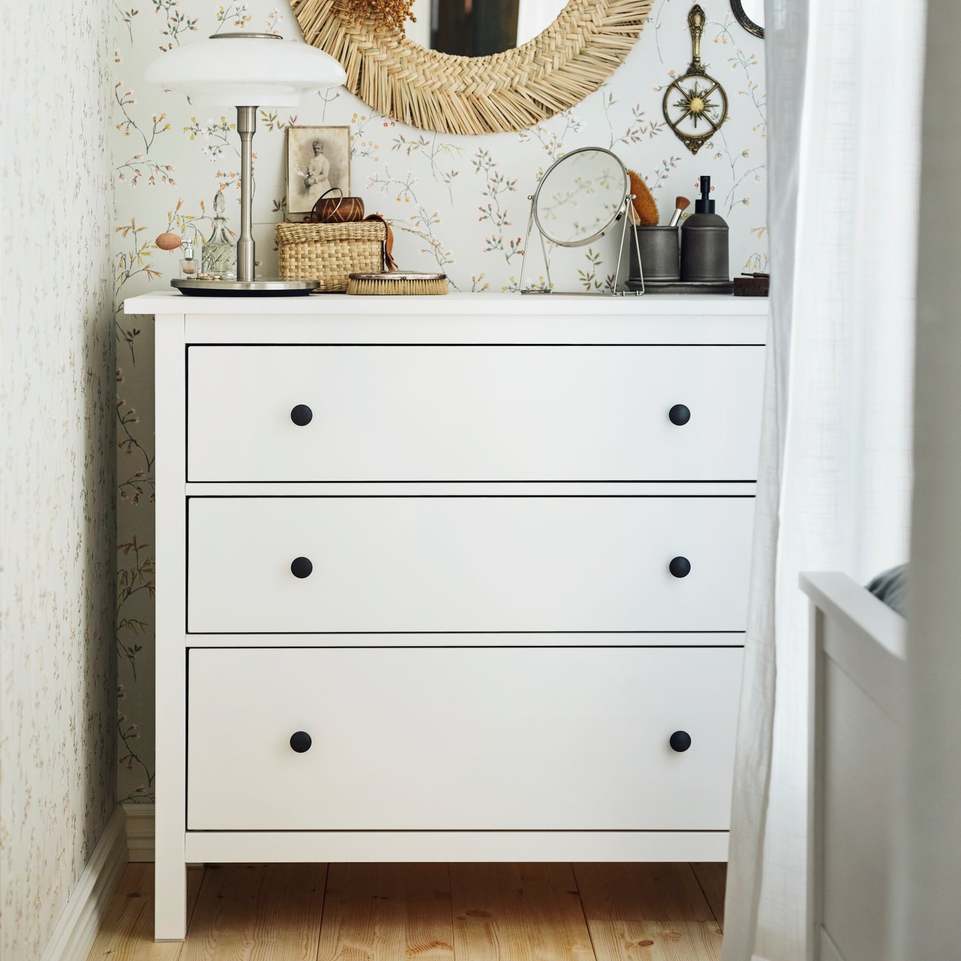 A silver-colour LASSBYN table mirror