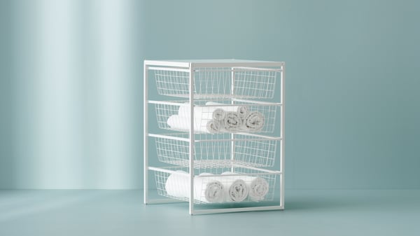 A white JONXEL storage unit with baskets filled with white towels
