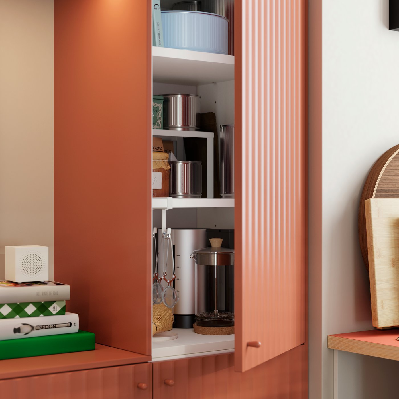 A kitchen cabinet with a TERRSJÖ accent door with a red-brown wave pattern is open and there are things stored inside.