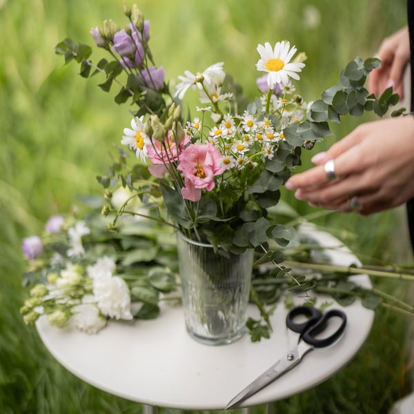 IKEA indoor/outdoor side table with vase and flowers