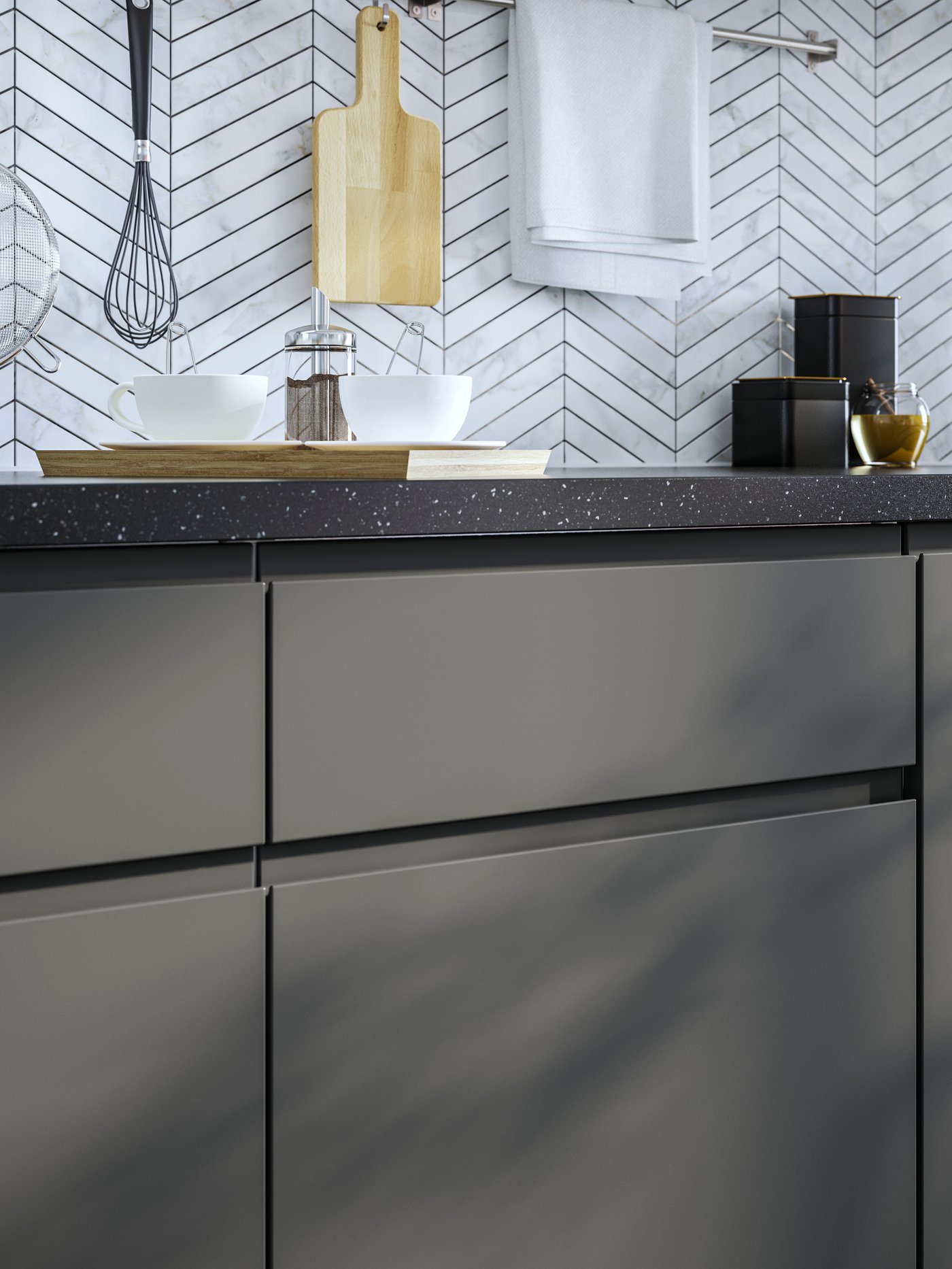 A dark grey VOXTORP drawer front