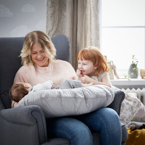 A Nordvalla dark grey STRANDMON wing chair in the childrens room