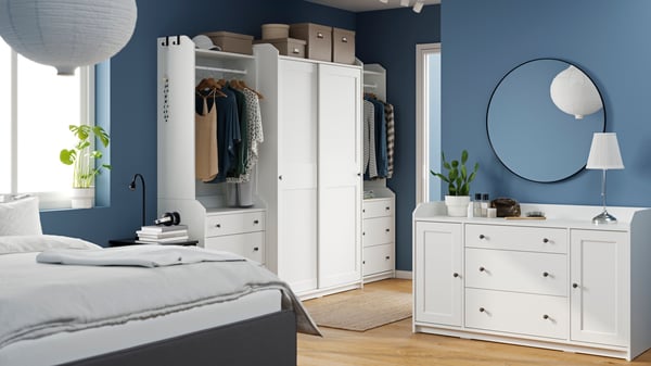 A white HAUGA wardrobe combination in the bedroom.