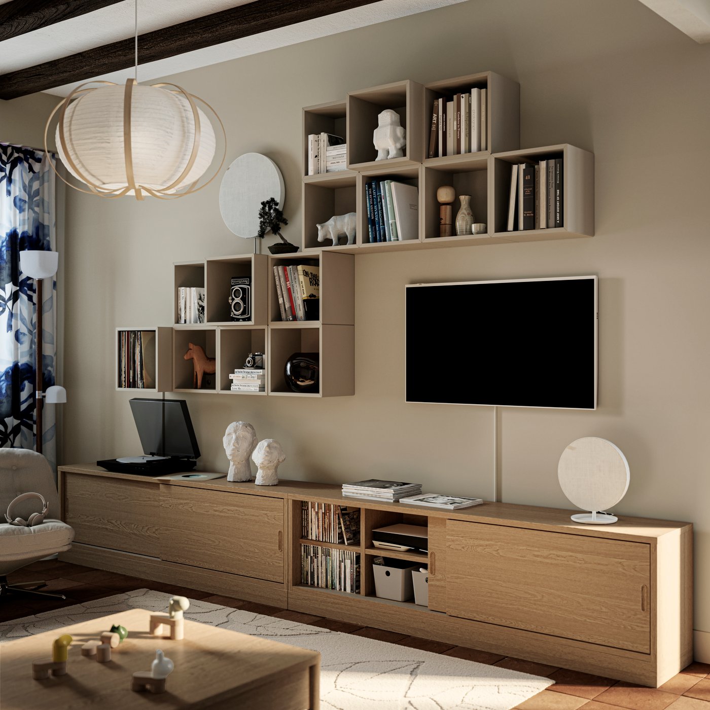 Different EKET cabinets and a TV are attached to a wall above two oak veneer TONSTAD TV benches in a living room.