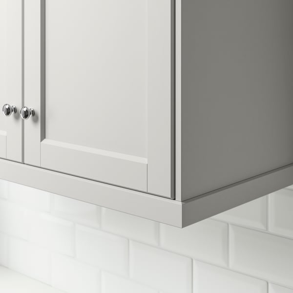 A light grey LERHYTTAN wall cabinet with decorative moulding.
