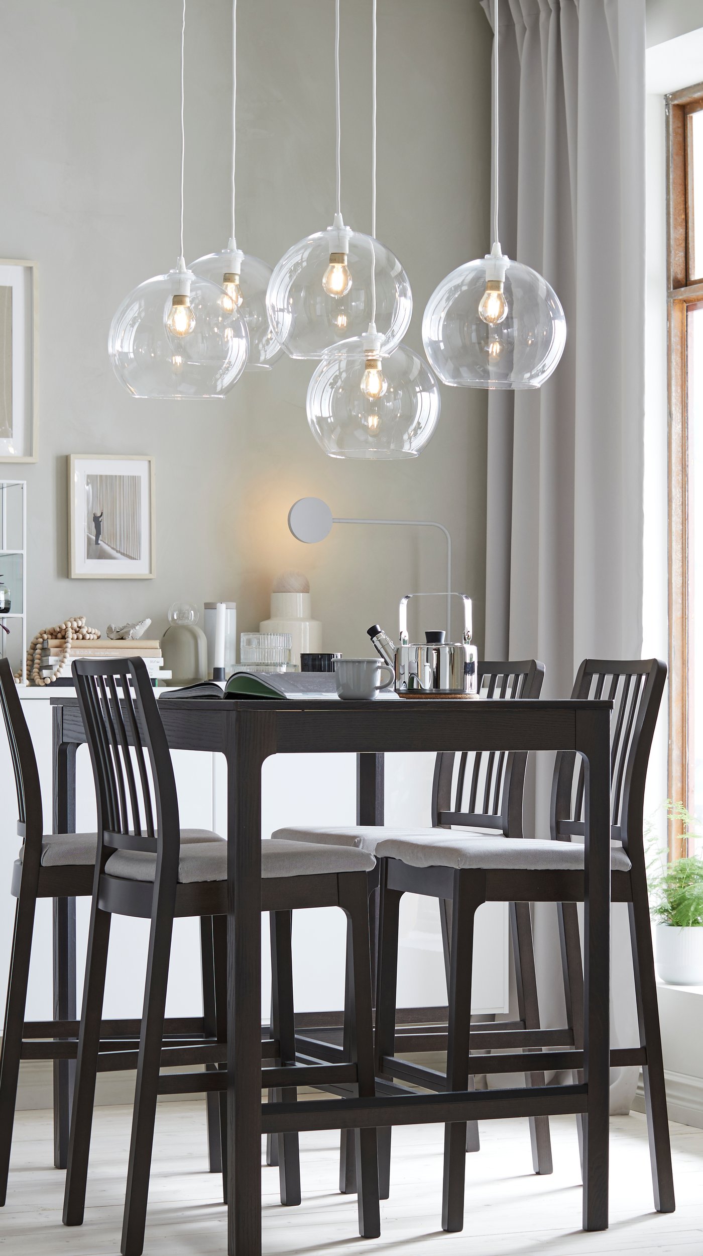 A dark brown EKEDALEN bar table in the dining room
